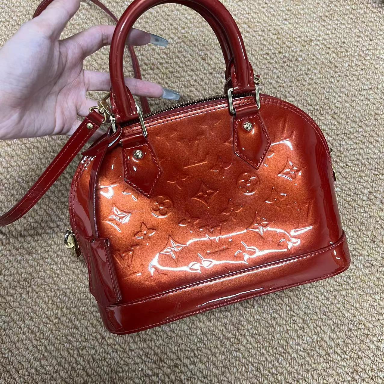 Louis Vuitton Alma BB patent leather handbag Red