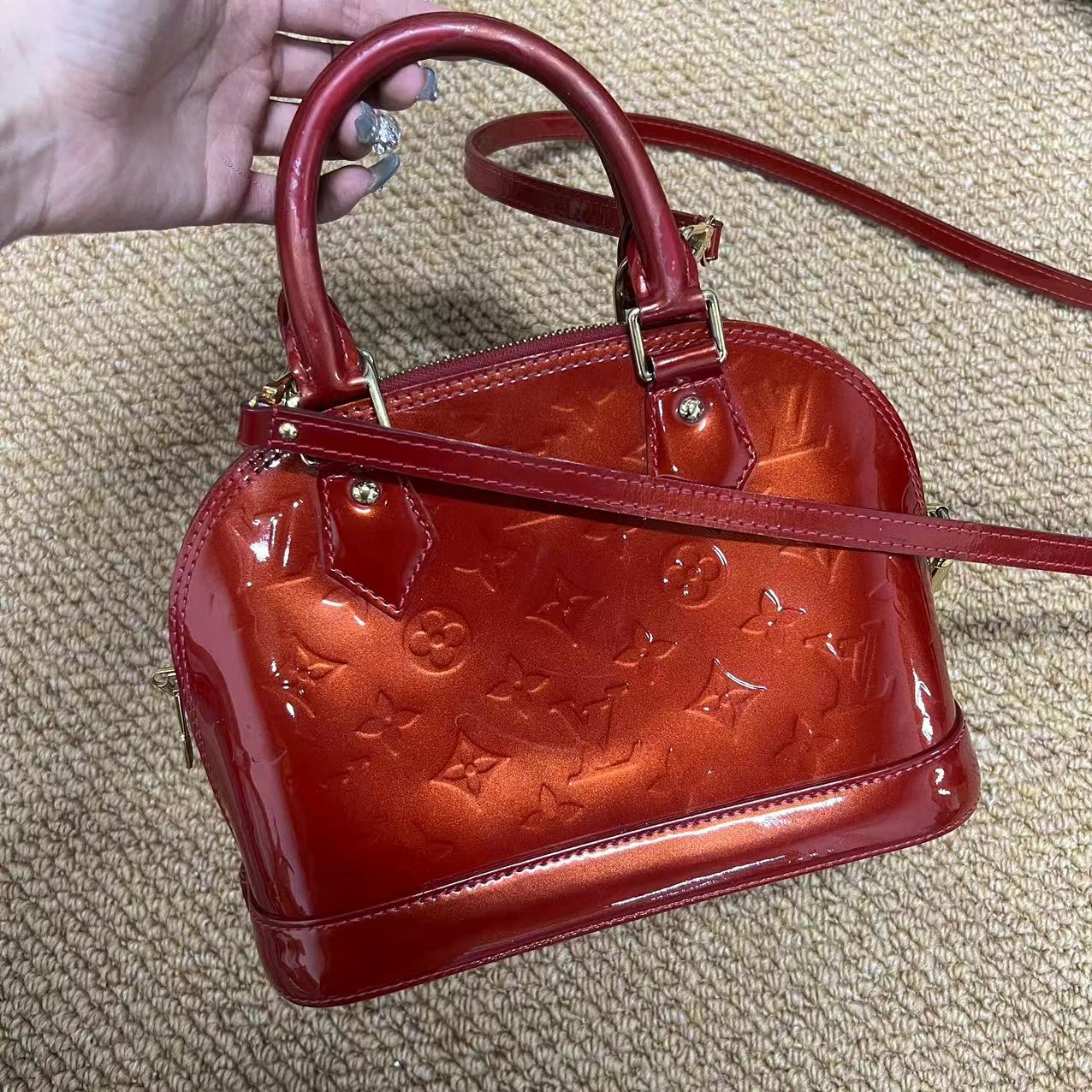 Louis Vuitton Alma BB patent leather handbag Red