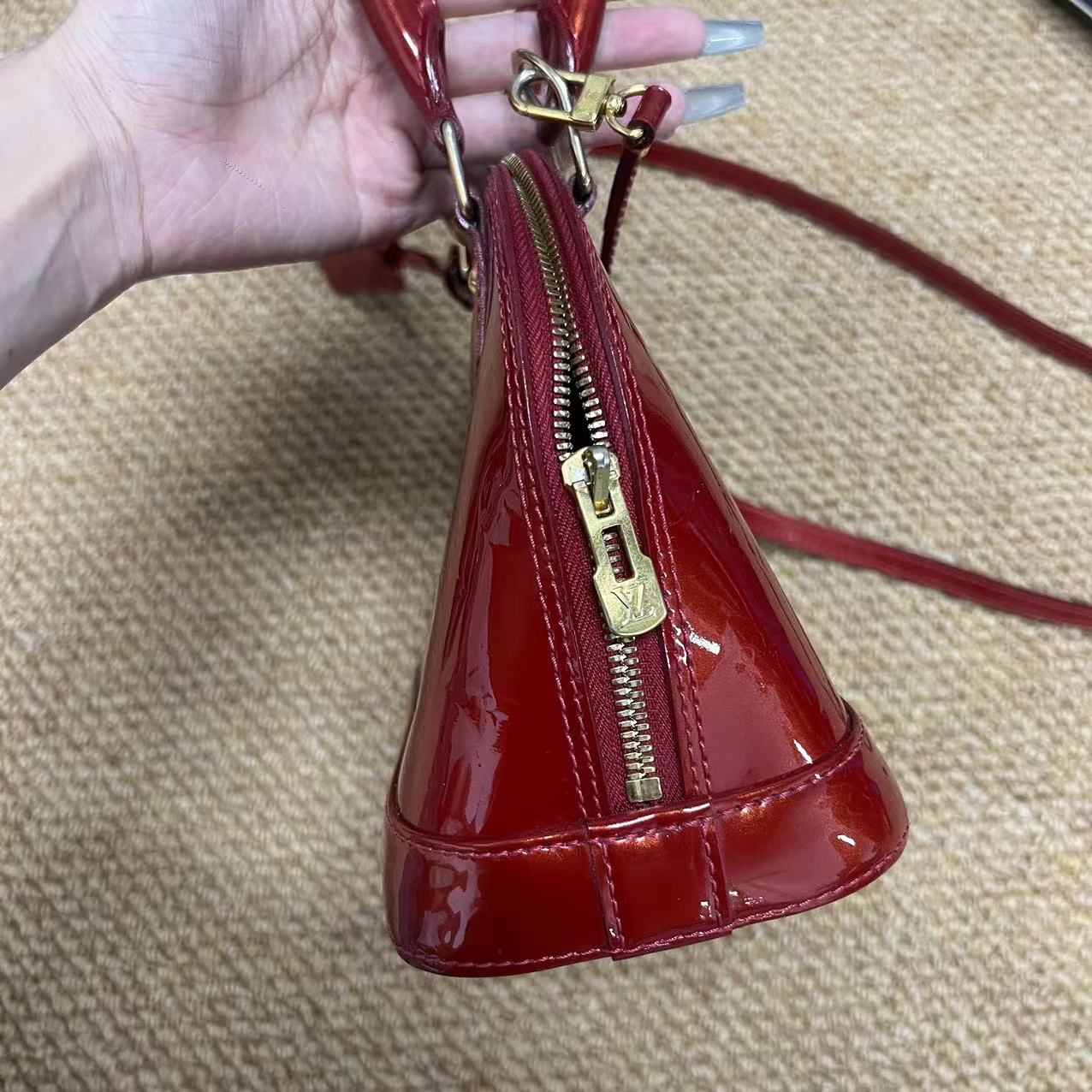 Louis Vuitton Alma BB patent leather handbag Red